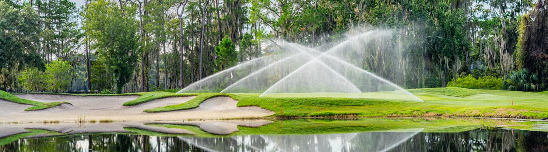 The Lake Nona golf course with Rain Bird sprinklers spraying water over the grass.